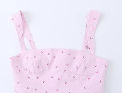 Close-up of the sweetheart neckline and straps of a pink striped floral camisole