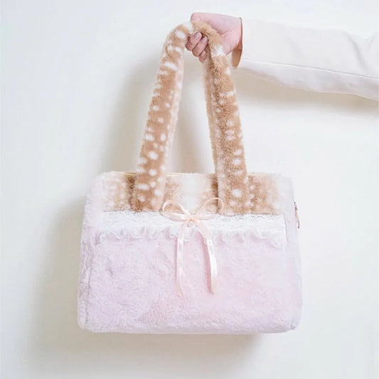 Hand holding a plush lace bow shoulder bag