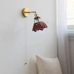 Wall-mounted lamp with floral glass shade in a room setting
