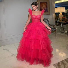 Golden Atelier red A-line prom dress with delicate ruffle straps, a fitted bodice, a flowing A-line skirt with layers of airy tulle, modeled on a woman in a formal setting. 2