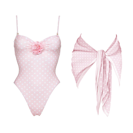 Pink polka dot one-piece swimsuit with floral accent and matching scarf.