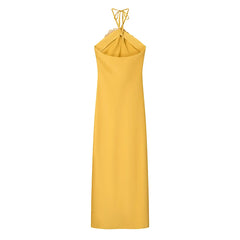 Yellow halter neck dress on a white background