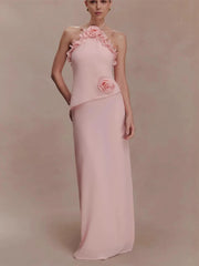 Pink evening gown with floral details on a plain background