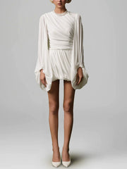 Full body view of long sleeve draped mini dress