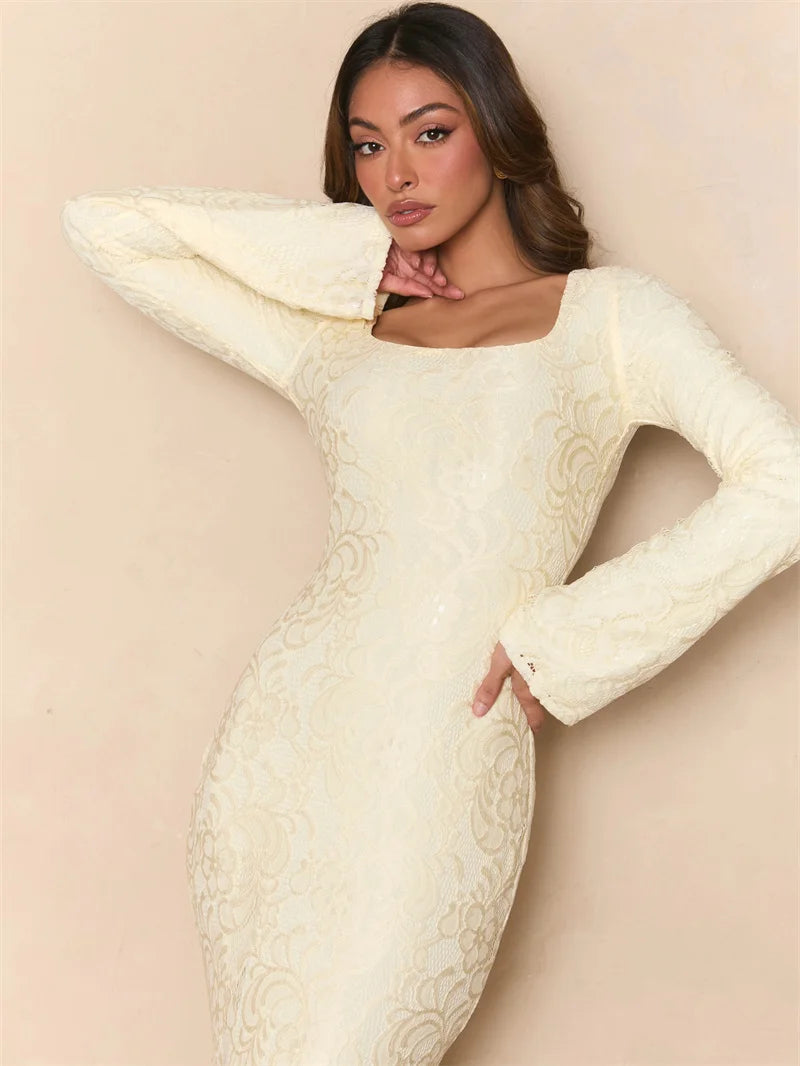 Woman wearing a white lace dress against a beige background