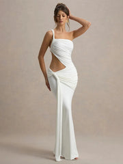 Woman wearing a white evening gown with cut-out design on a beige background