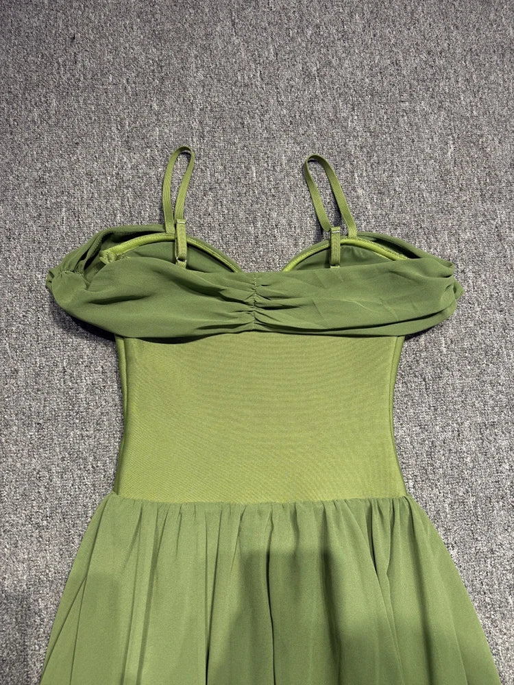Green dress with thin straps on a gray textured background