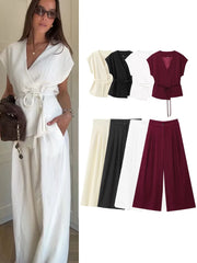 Woman wearing a white outfit with color swatches of top and pants.