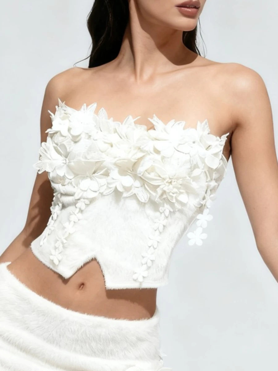 White strapless dress with floral details on a plain background