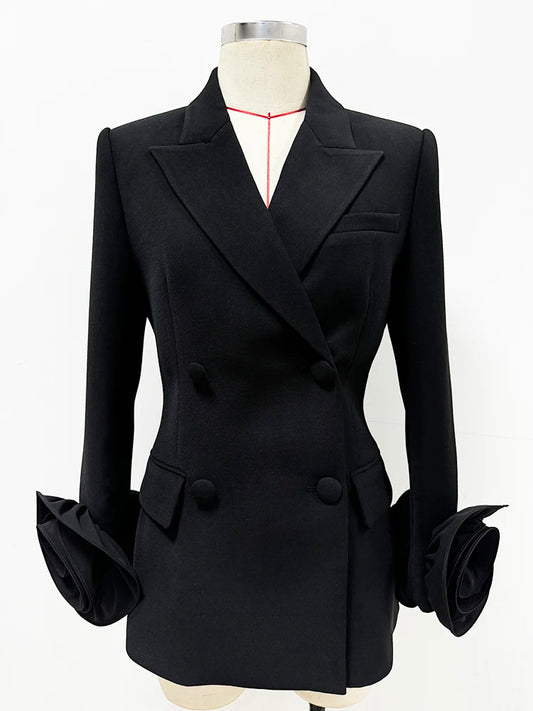 Sculpted double-breasted black blazer with dramatic floral cuffs shown on a mannequin.