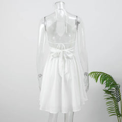 White dress on a mannequin with a plant on a white background