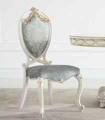 Decorative chair with gray cushion and ornate backrest in a room setting.