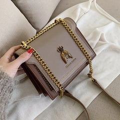 A stylish PU leather crossbody bag showcased against a neutral background, highlighting its elegant design and textured material.