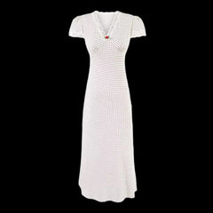 White dress with black polka dots on a black background