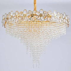 Decorative chandelier with crystal beads and gold accents on a light gray background