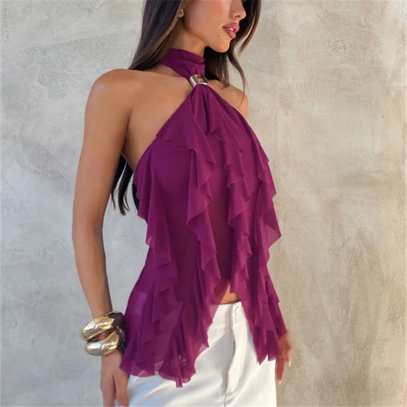 Woman wearing a purple ruffled top against a neutral background