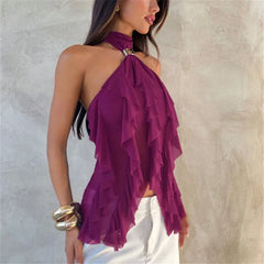 Woman wearing a purple ruffled top against a neutral background