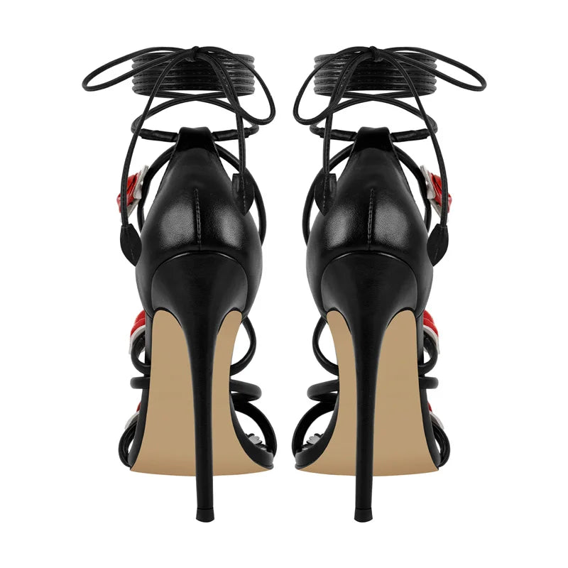 Back view of black lace-up stiletto heeled sandals with rose details.