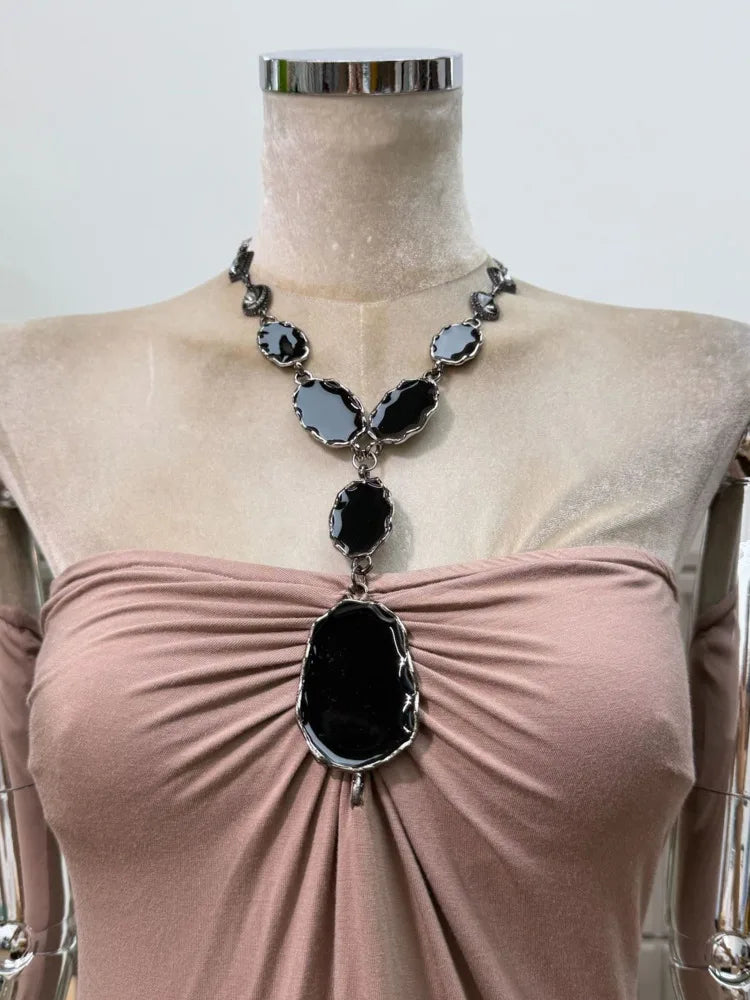 Close-up of the gemstone embellishment on the ruched bodice