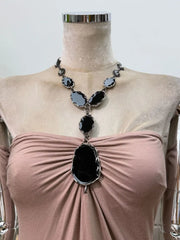 Close-up of the gemstone embellishment on the ruched bodice