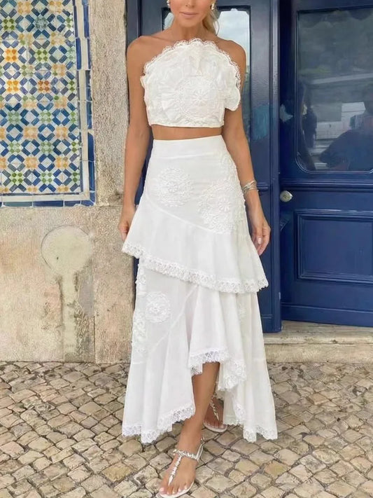White floral lace one-shoulder crop top with an asymmetric ruffle midi skirt.