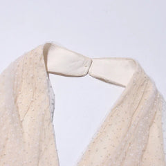 Close-up of a beige fabric with a collar on a light gray background
