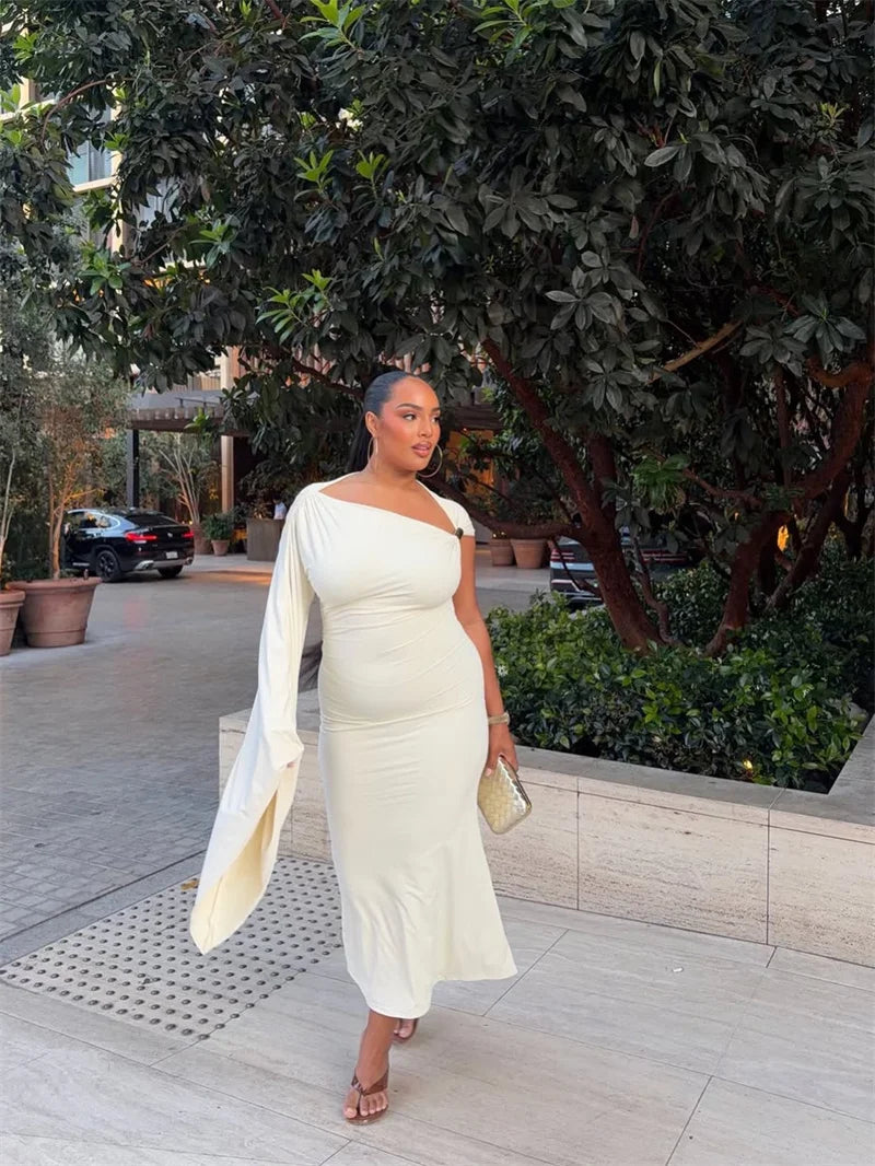 Model wearing a cream one shoulder midi dress