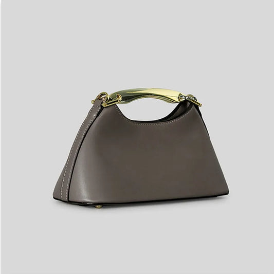 Gray trapezoid top handle bag with a gold metal bar handle