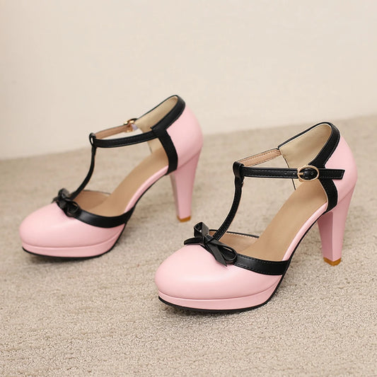 Pink T-strap platform block heel pump with black trim and bow detail