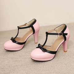 Pink T-strap platform block heel pump with black trim and bow detail