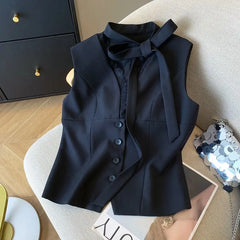 Black vest with buttons on a chair in a room setting