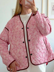 Quilted jacket with pink paisley print and dark contrast trim