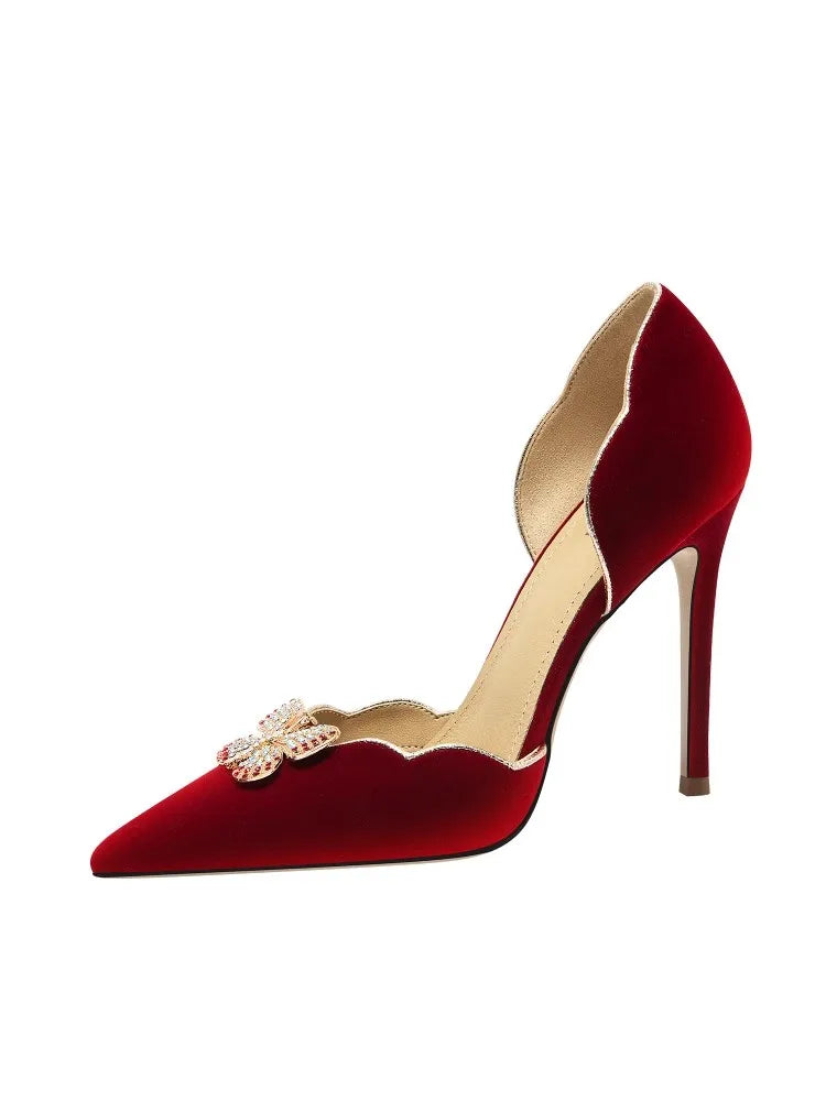 Red high-heeled shoe with gold accents on a white background