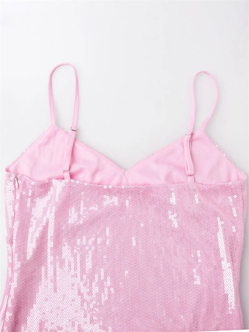 Pink sequin dress with thin straps on a light pink background