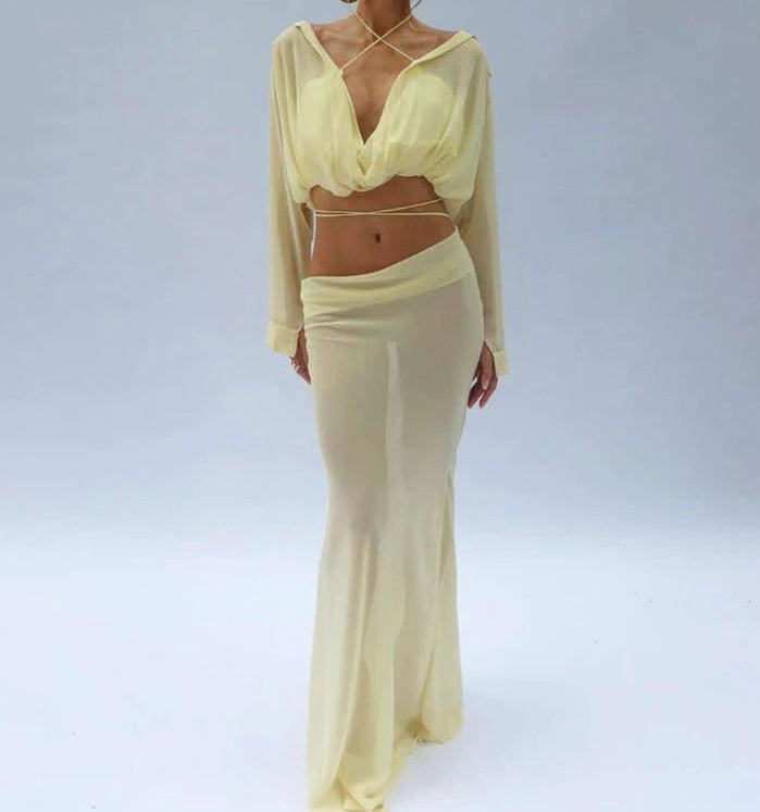 Woman wearing a light yellow outfit on a plain background