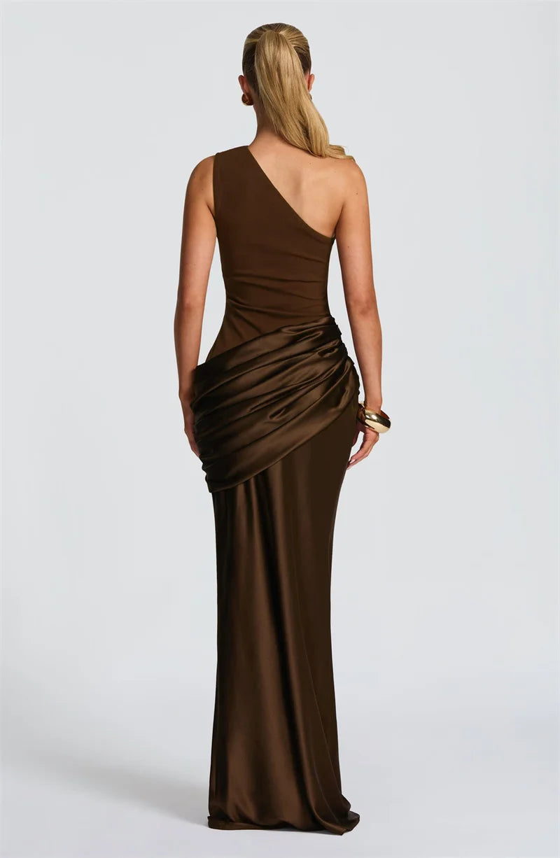 Woman wearing a brown one-shoulder evening gown on a white background
