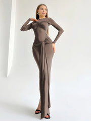 Women's long sleeve dress with pleats and a draped silhouette.