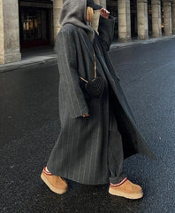 Women's long coat with a striped pattern and oversized fit.