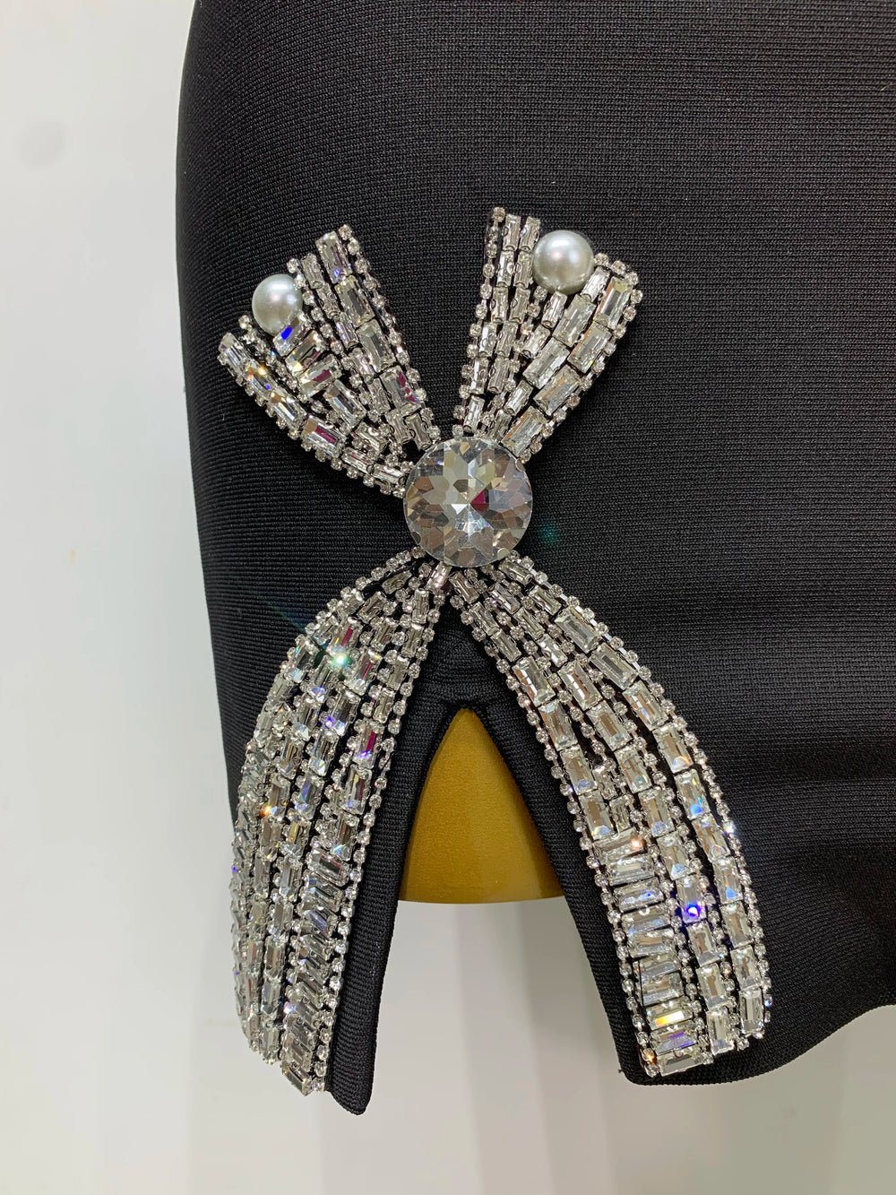 Elegant brooch with crystal details on a black background