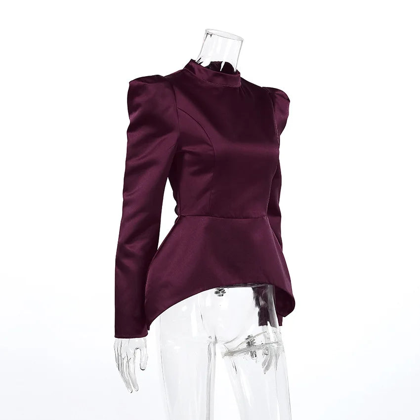 Purple peplum top on a mannequin against a white background