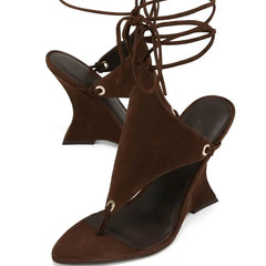 Brown high-heeled sandals with strap details on a white background