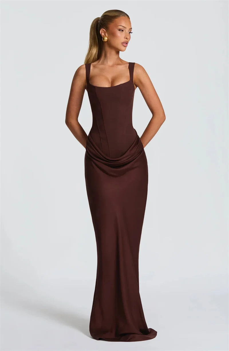 Woman wearing a brown evening gown on a light gray background