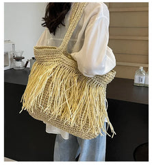 Person holding a yellow fringed bag in an indoor setting