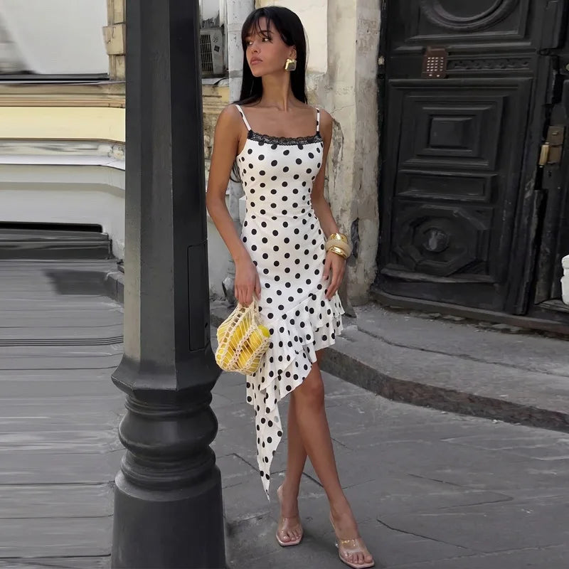 Model posing in a polka dot lace trim asymmetric ruffle hem mini dress