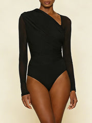 Black long-sleeve bodysuit worn by a model on a beige background