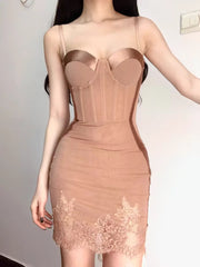 Beige bodycon dress with lace details on a plain background