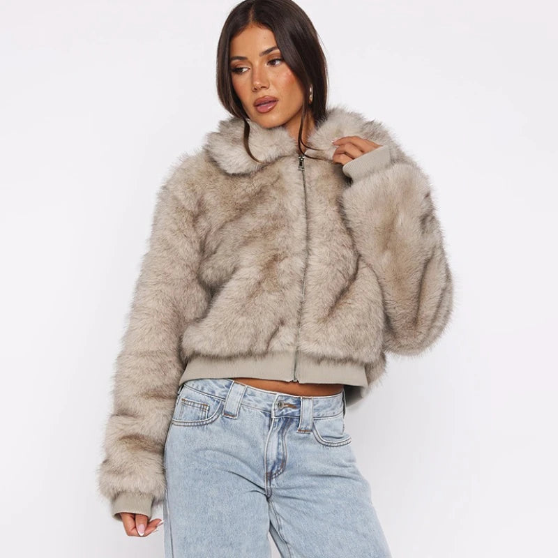 Woman wearing a fluffy beige jacket and light blue jeans