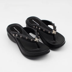 Black platform thong sandals with silver metal stud details and a cross charm.