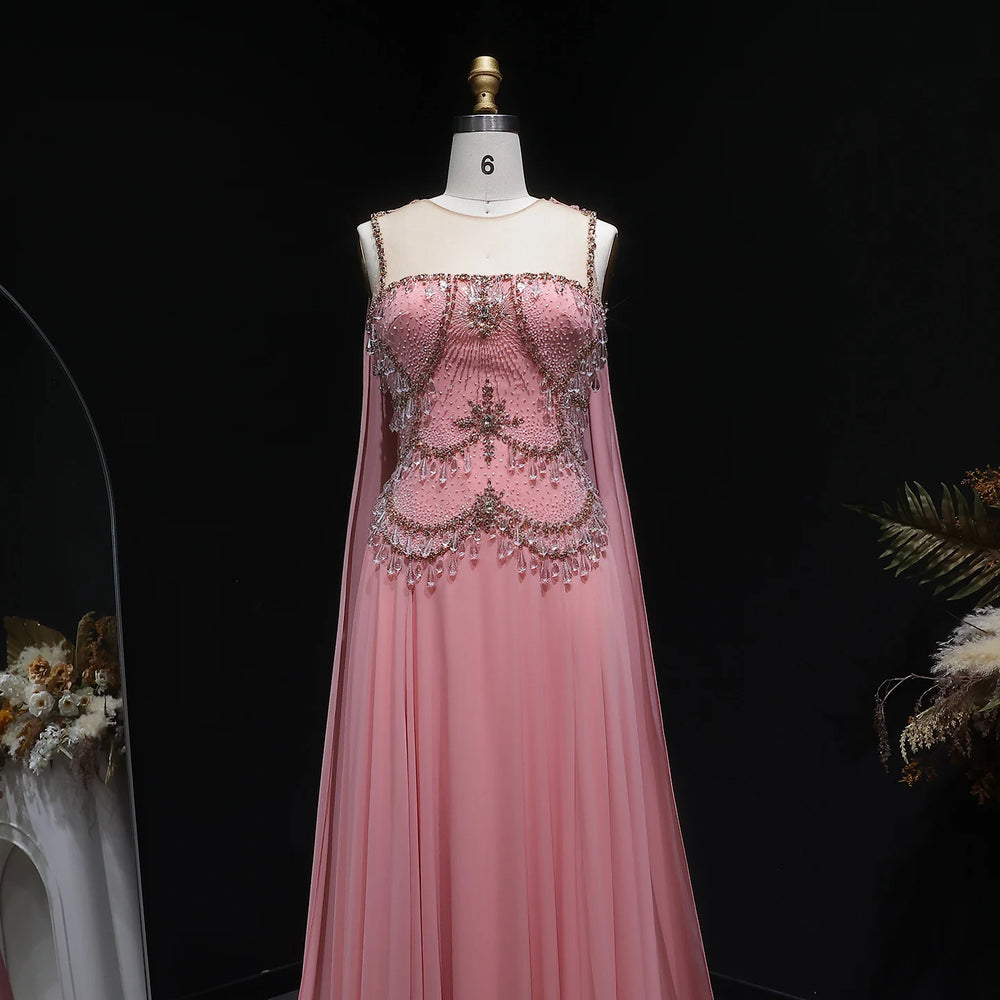 Pink evening gown with intricate beading on a mannequin against a dark background