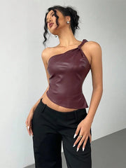 Woman wearing a burgundy one-shoulder top and black pants against a plain background